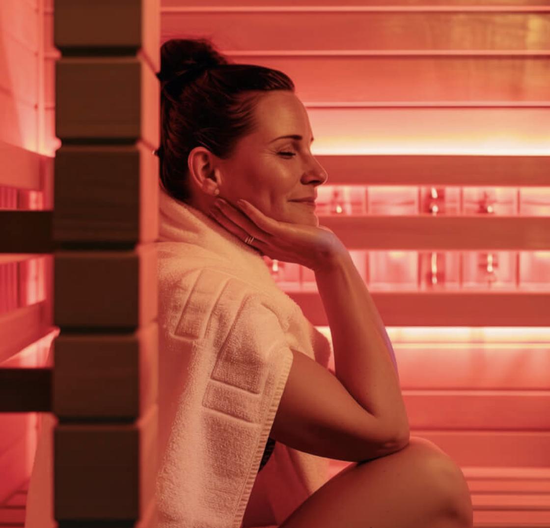 Woman relaxing in a wellness sauna, representing health and personal care products